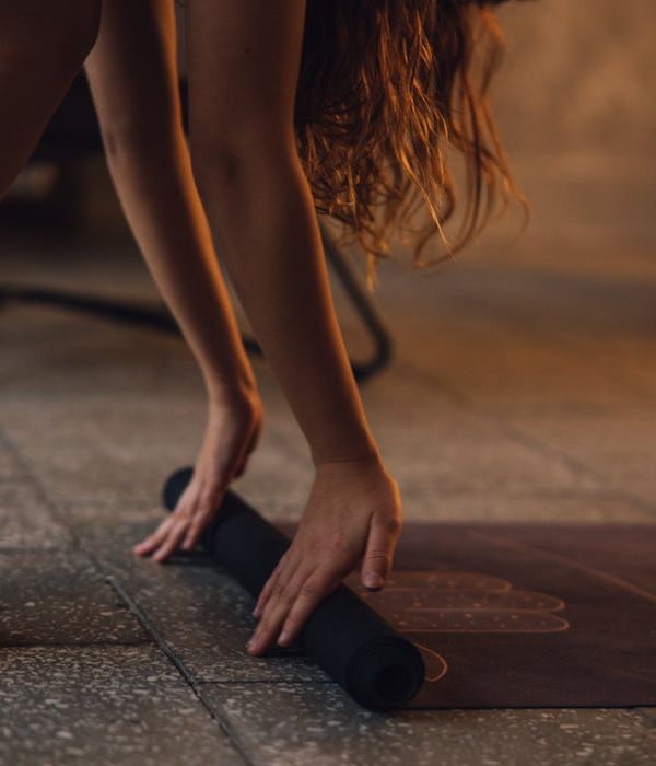 Woman practicing gentle neck stretch in a calm environment.